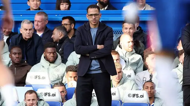 Chelsea head coach Liam Rosenior watches on.