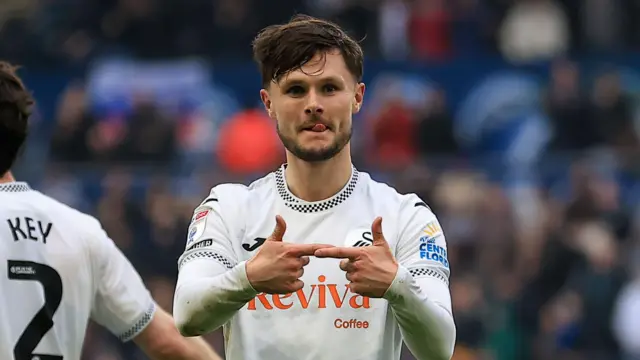 Swansea City striker Liam Cullen celebrates scoring a goal
