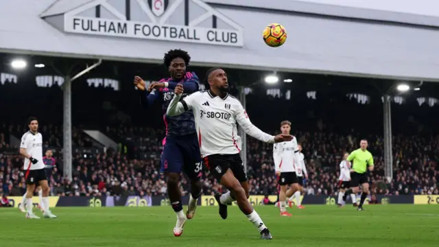 Alex Iwobi  contends for the aerial ball with Ola Aina