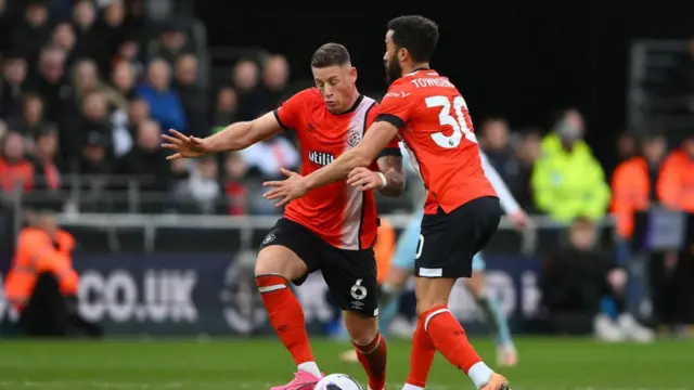 Andros Townsend of Luton Town clashing with his teammate, Ross Barkley of Luton Town, during the Premier League match between Luton Town and Nottingham Forest at Kenilworth Road