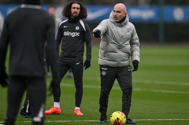 Enzo Maresca taking a Chelsea training session with Marc Cucurella in the background
