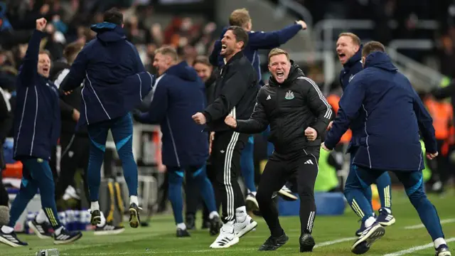 Eddie Howe and his coaching staff celebrate a goal 