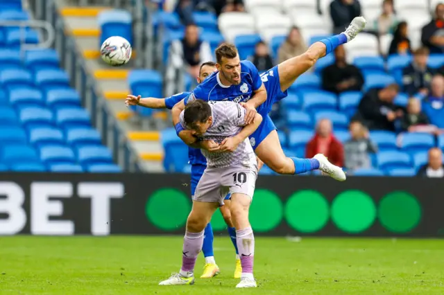 Dimitrios Goutas wins a header against Rotherham earlier this season