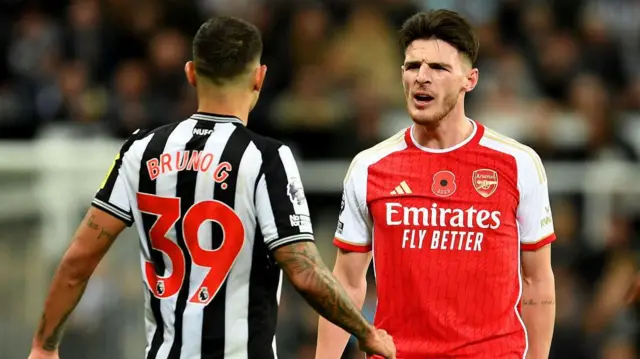 Bruno Guimaraes of Newcastle United clashes with Declan Rice of Arsenal during the Premier League match between Newcastle United and Arsenal FC.