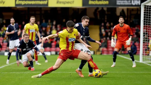 Luca Kjerrumgaard battling for the ball against Millwall at Vicarage Road