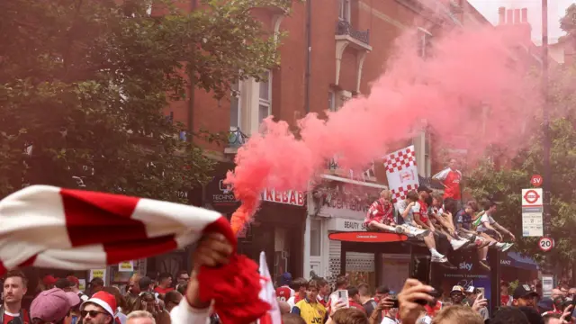 Fans of Arsenal gather in the streets prior to the Arsenal trophy parade