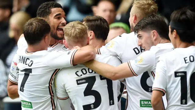 Swansea players celebrate earlier this season