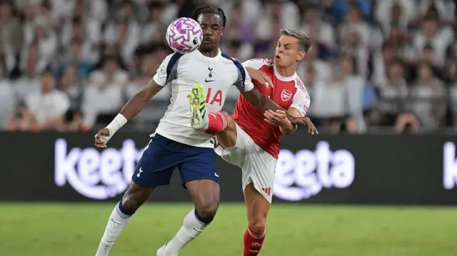 Mathys Tel of Tottenham Hotspur is challenged by Leandro Trossard of Arsenal during the Pre-Season Friendly match between Arsenal and Tottenham Hotspur at Kai Tak Sports Park