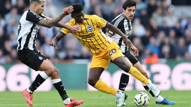 Carlos Baleba dribbles with the ball while in action for Brighton