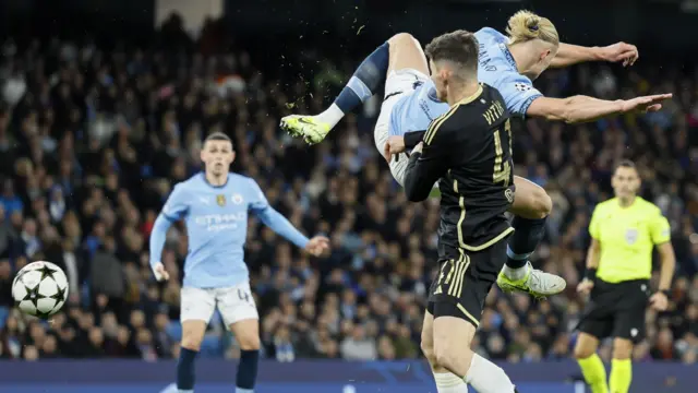 Phil Foden looks on as Erling Haaland scores acrobatic goal