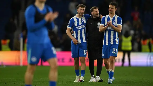 Fabian Huerzeler, Manager of Brighton & Hove Albion, celebrates with Jack Hinshelwood and Olivier Boscagli during the Premier League match between Brighton & Hove Albion and Chelsea at Amex Stadium on April 21, 2026 in Brighton, England.
