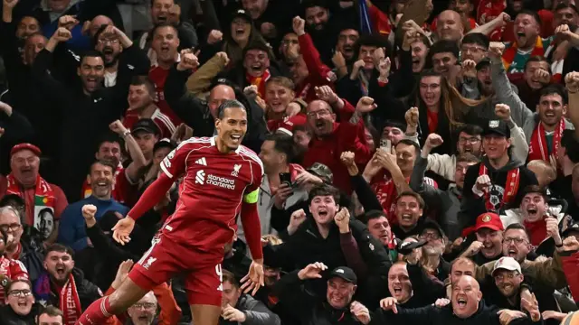 Virgil van Dijk celebrates in front of The Kop