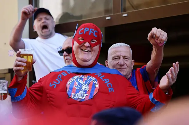 A Crystal Palace fan dressed as Robin from Batman. His costume says Super Eagle Palace
