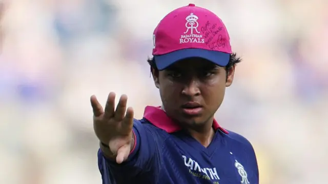 Rajasthan Royals' Vaibhav Sooryavanshi wears a cap with a message and signed by Royal Challengers Bengaluru's Virat Kohli 