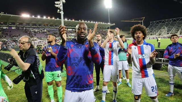 Crystal Palace players celebrate with their fans.