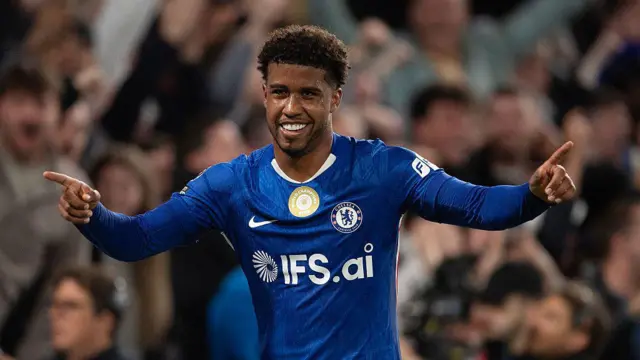 Andrey Santos with both arms outstretched as he celebrates scoring for Chelsea