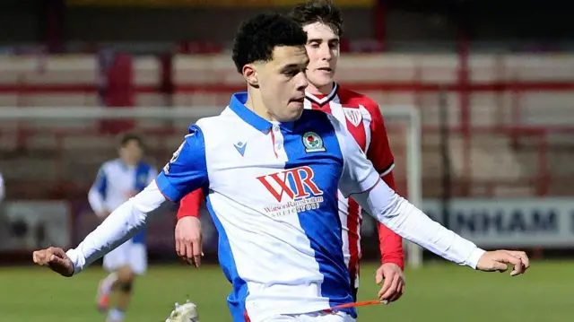 Blackburn Rovers player Zack Stritch in action, in their blue and white halved shirt