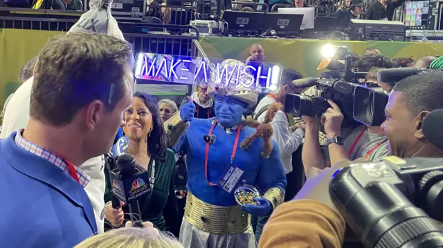 A media member dressed as a genie on Super Bowl Opening Night in 2025