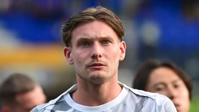 Taylor Gardner-Hickman stares straight ahead with a focused look on his face.