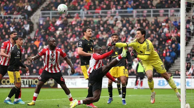 Senne Lammens of Manchester United clears the ball under pressure from Brian Brobbey of Sunderland