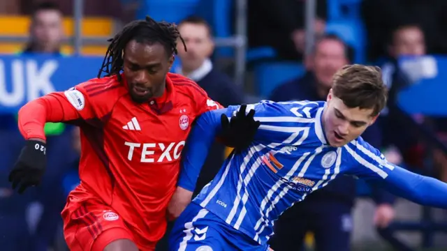 Aberdeen's Toyosi Olusanya and Kilmarnock's Findlay Curtis