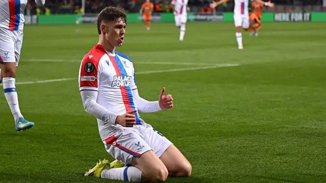 Jorgen Strand Larsen sliding on his knees after scoring for Crystal Palace against Shakhtar Donetsk