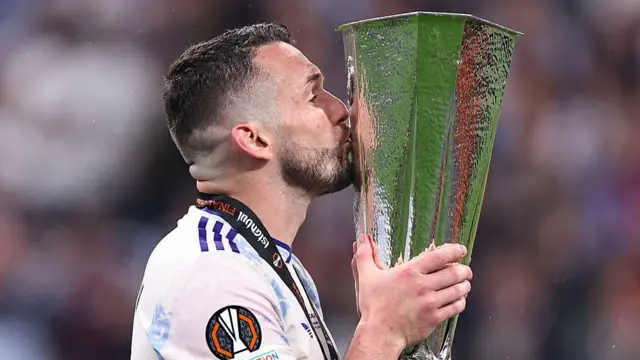 Aston Villa captain John McGinn kisses the Europa League trophy