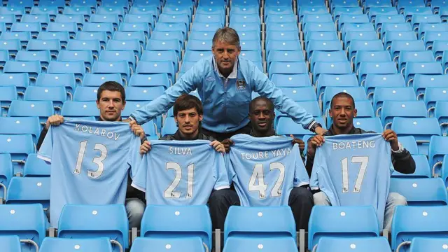 Manager Roberto Mancini (C) poses with new signings (L-R) Aleksandar Kolarov, David Silva, Yaya Toure and Jerome Boateng