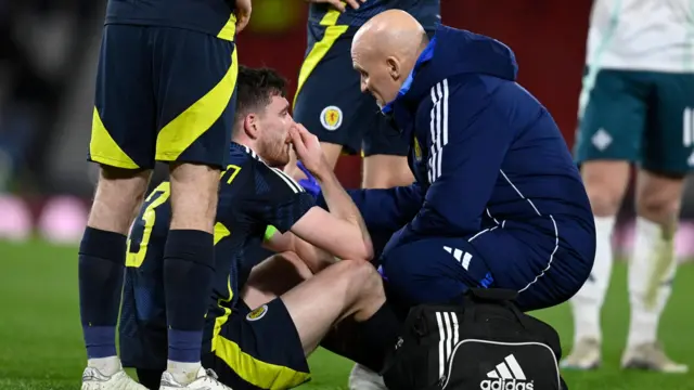 Andy Robertson on the ground receiving treatment before being forced off with a first half injury during the friendly against Northern Ireland