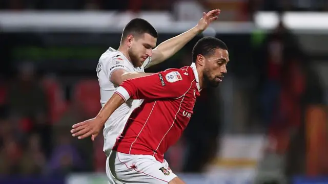 Zan Vipotnik battles with Zak Vyner during Wrexham's most recent game against Swansea 