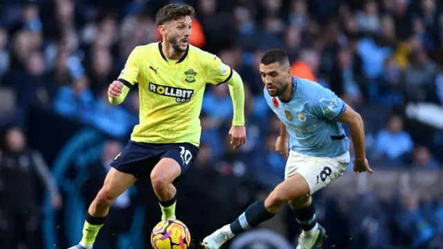 Adam Lallana of Southampton runs with the ball whilst under pressure from Mateo Kovacic of Manchester City during the Premier League match between Manchester City FC and Southampton FC at Etihad Stadium on October 26, 2024