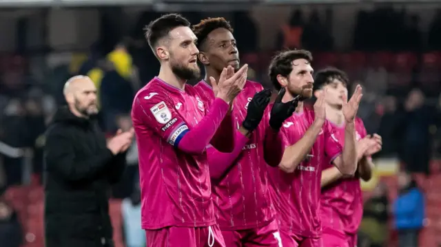 Swansea City players applaud supporters at Watford