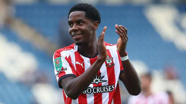 Romeo Akachukwu applauds the fans after playing against Colchester
