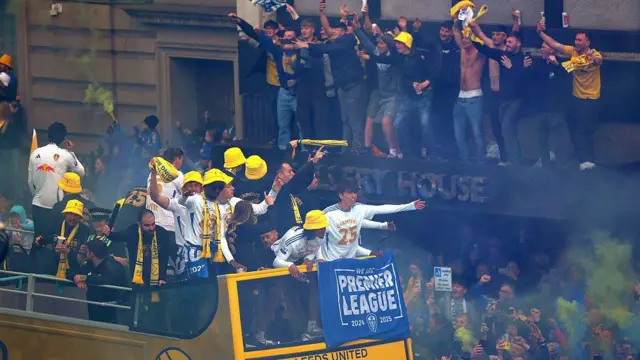 Leeds United players celebrate on the bus