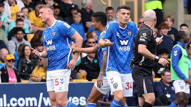 Sunderland captain Granit Xhaka argues the case for teammate Dan Ballard after he was shown a red card