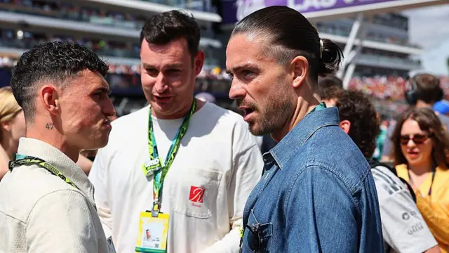 Jack Grealish talking to Phil Foden at the F1 Grand Prix of Great Britain at Silverstone Circuit 