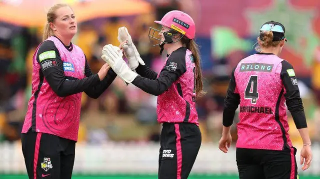 Sydney Sixers spinner Sophie Ecclestone (left) celebrates taking a wicket