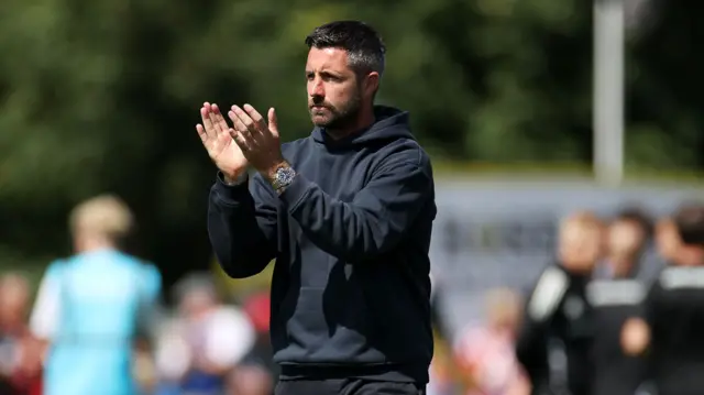 Swansea City head coach Alan Sheehan applauds the fans