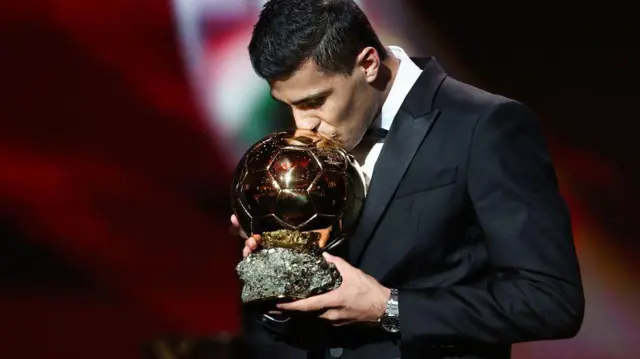 Manchester City's Spanish midfielder Rodri receives the Ballon d'Or award