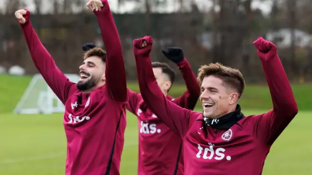 Hearts' Claudio Braga Cammy Devlin cheer during training