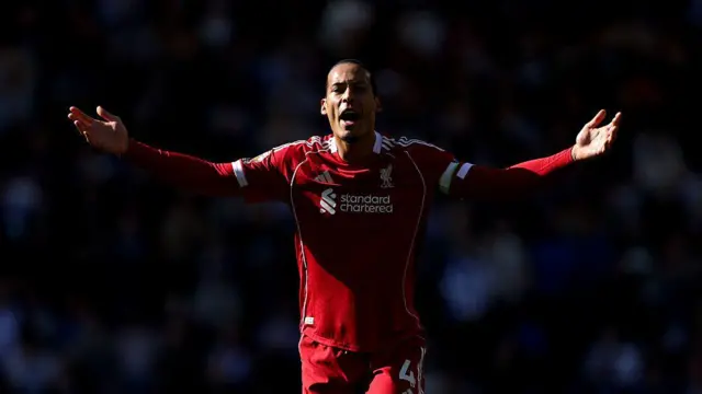 Virgil van Dijk holds his arms outstretched