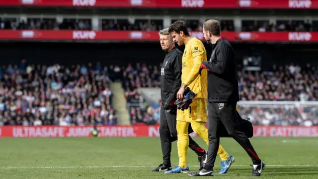 Alisson of Liverpool walks off injured at Selhurst Park 