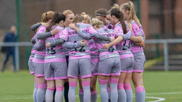 The Partick Thistle team huddle together during a Scottish Power Women's Premier League match between Glasgow City and Partick Thistle