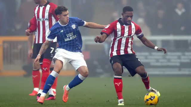 Alex Robertson of Cardiff and Tendayi Darikwa of Lincoln during the clubs' meeting in December 