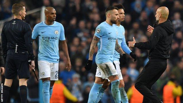 Pep Guardiola escorts his players off the pitch after they surrounded the referee at the end of a controversial first-half