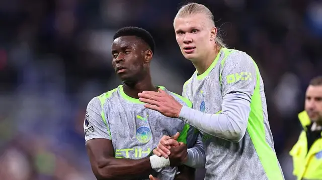Erling Haaland consoles a dejected Marc Guehi of Manchester City at full time 