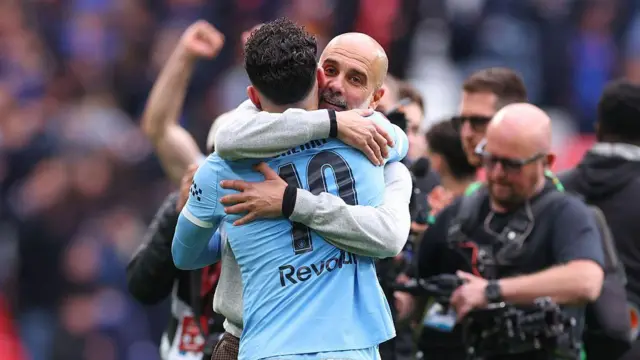 Pep Guardiola celebrates with Rayan Cherki
