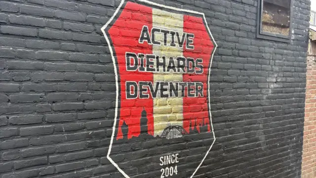 A painted Deventer badge wall outside the Go Ahead stadium