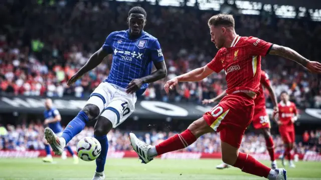 Ipswich Town's Axel Tuanzebe in action against Liverpool's Alexis Mac Allister