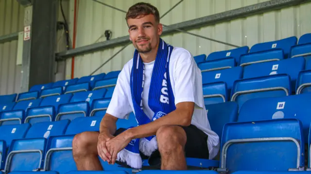 Reece Johnson poses for a photo after signing for Eastleigh on loan
